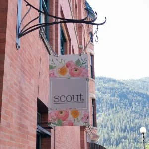 a hanging rectangular blade sign on the side of a building