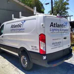 custom cut vinyl graphics and vehicle letters on the side and back of a work van
